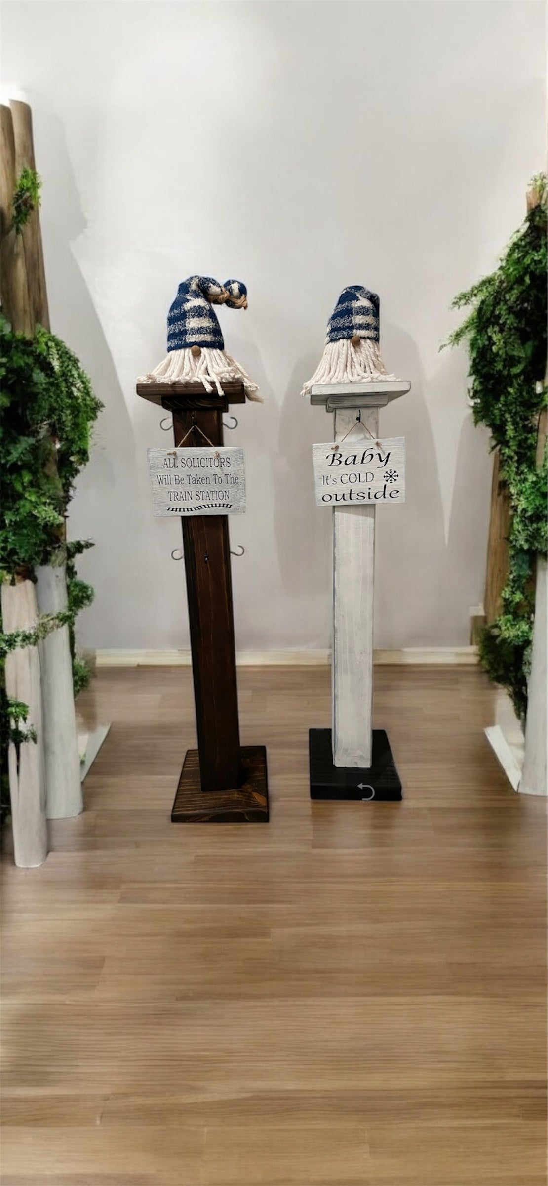 A solid wood decorative porch post with hooks at the top, displayed in a home decor setting.