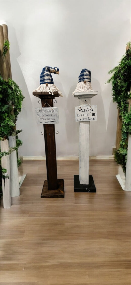 A solid wood decorative porch post with hooks at the top, displayed in a home decor setting.